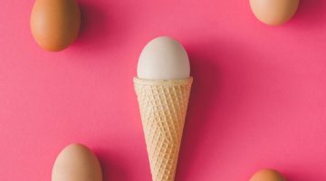 ice-cream-cone-with-egg-pink-surface_404561-719